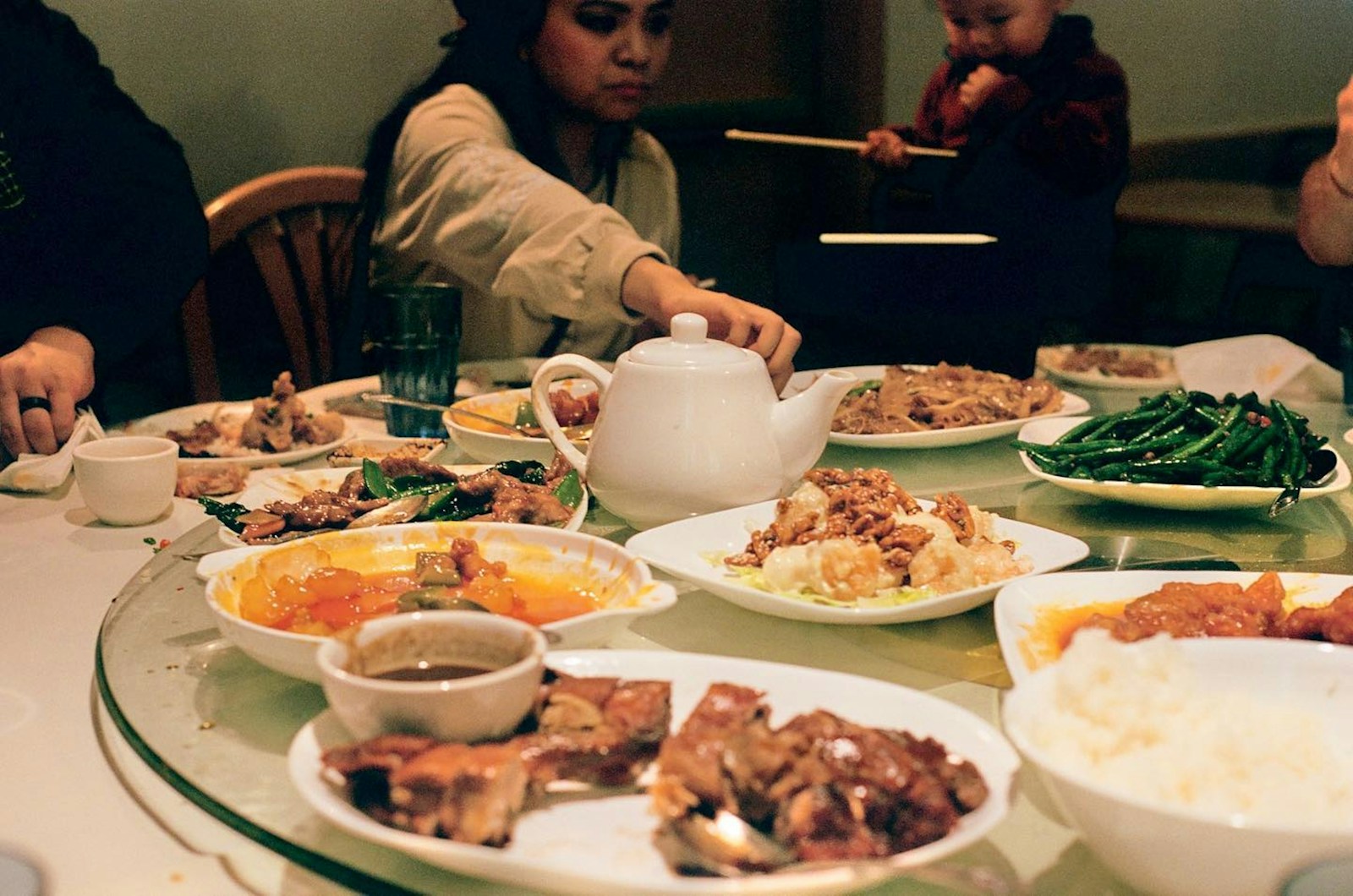 A group of people sitting around a table full of food