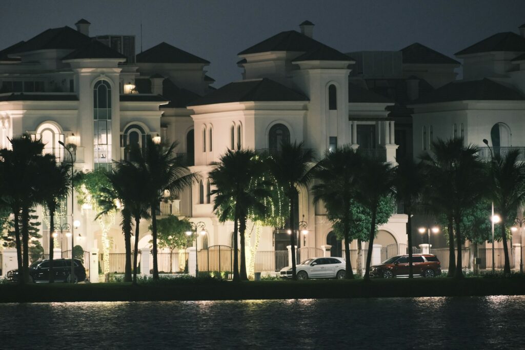 a large white building with palm trees in front of it