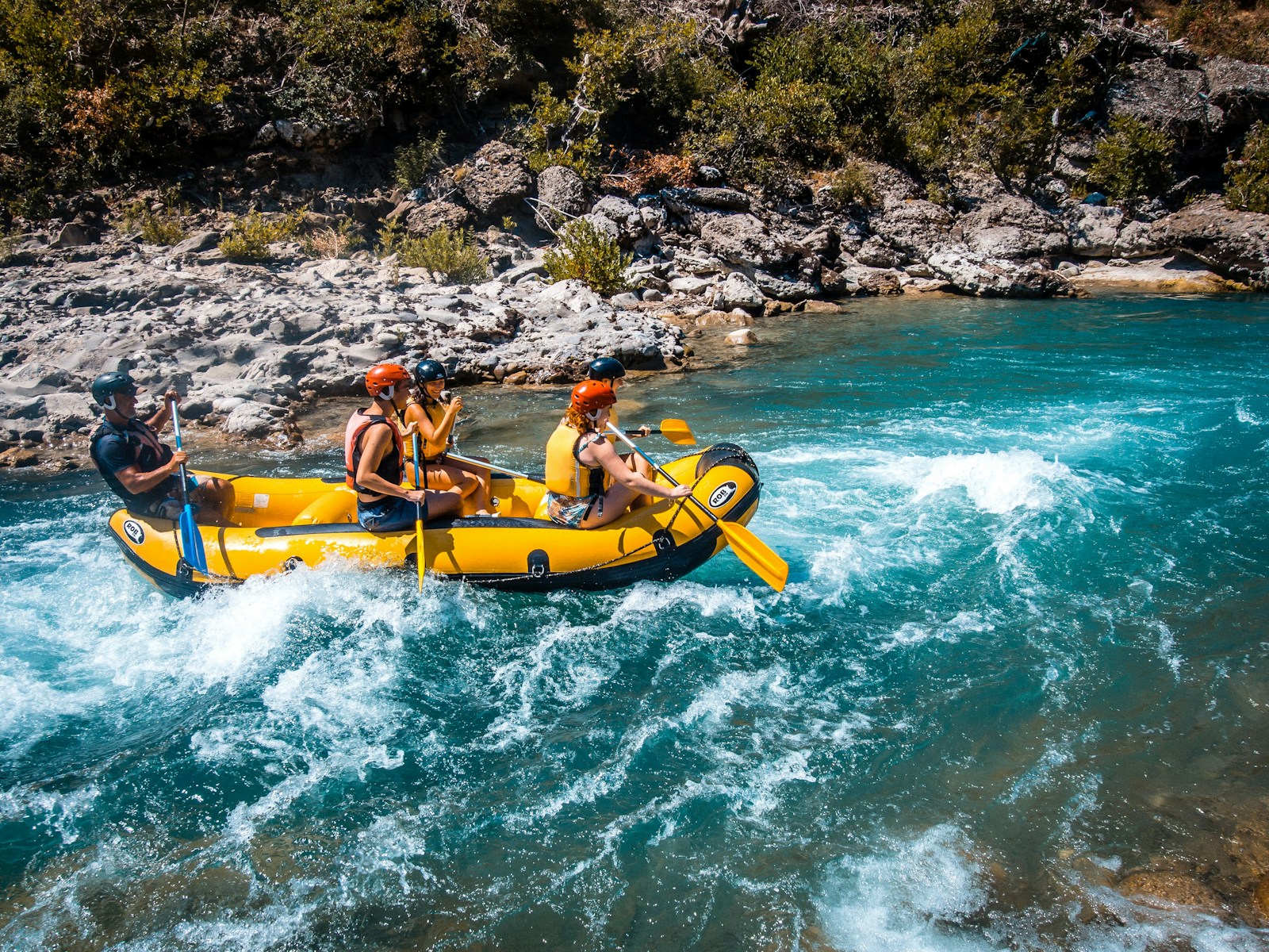 a group of people riding on the back of a raft