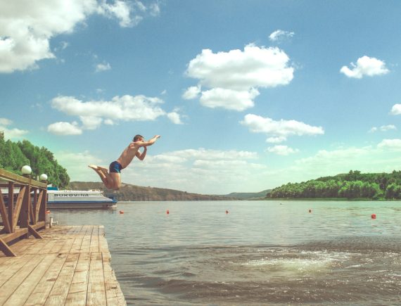 man diving on lake