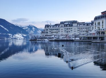 a large body of water surrounded by snow covered mountains